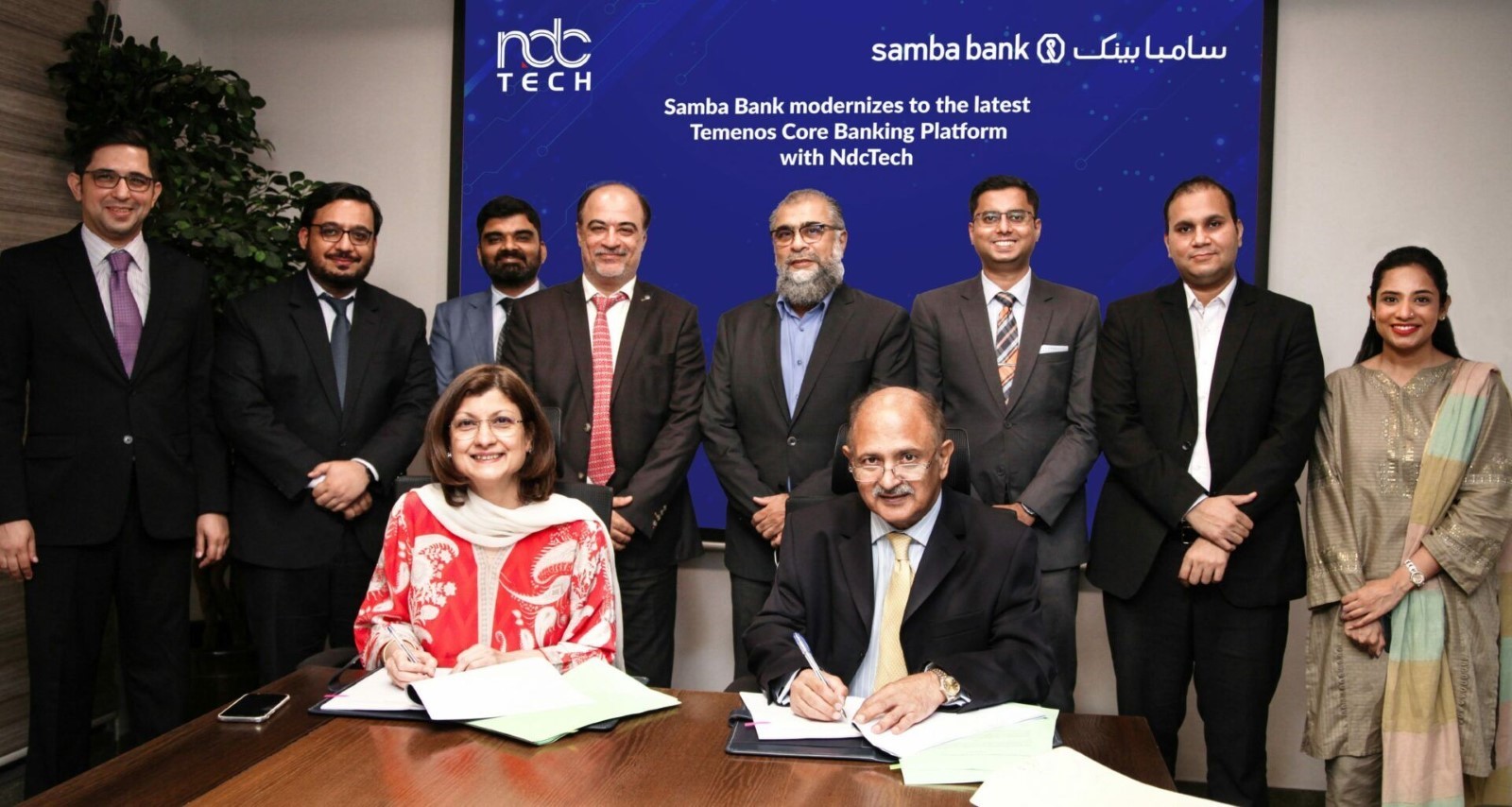 The picture shows the signing ceremony, with Mr. Shahid Sattar, CEO & President Samba Bank, (right) & Ms. Ammara Masood, CEO & President NdcTech, (left) along with senior executives of both organizations