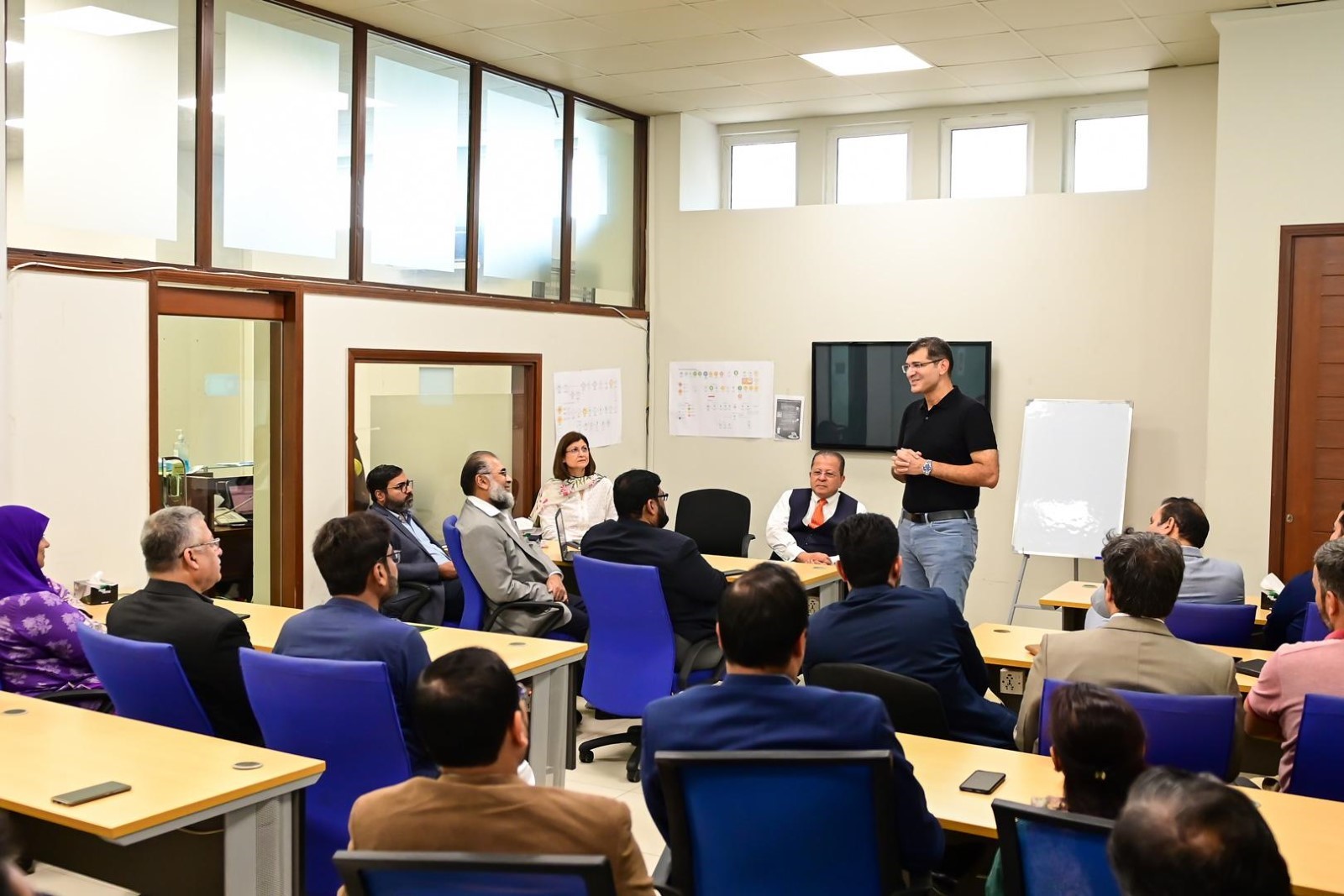 A person standing in front of a group of people
Description automatically generated